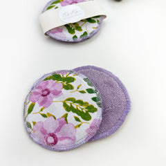 Reusable facial rounds with floral print, purple trim, and soft material, by Koko