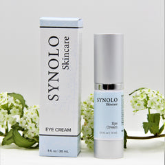 Eye cream product with blue and silver packaging, brand name SYNOLO Skincare, and floral accents
