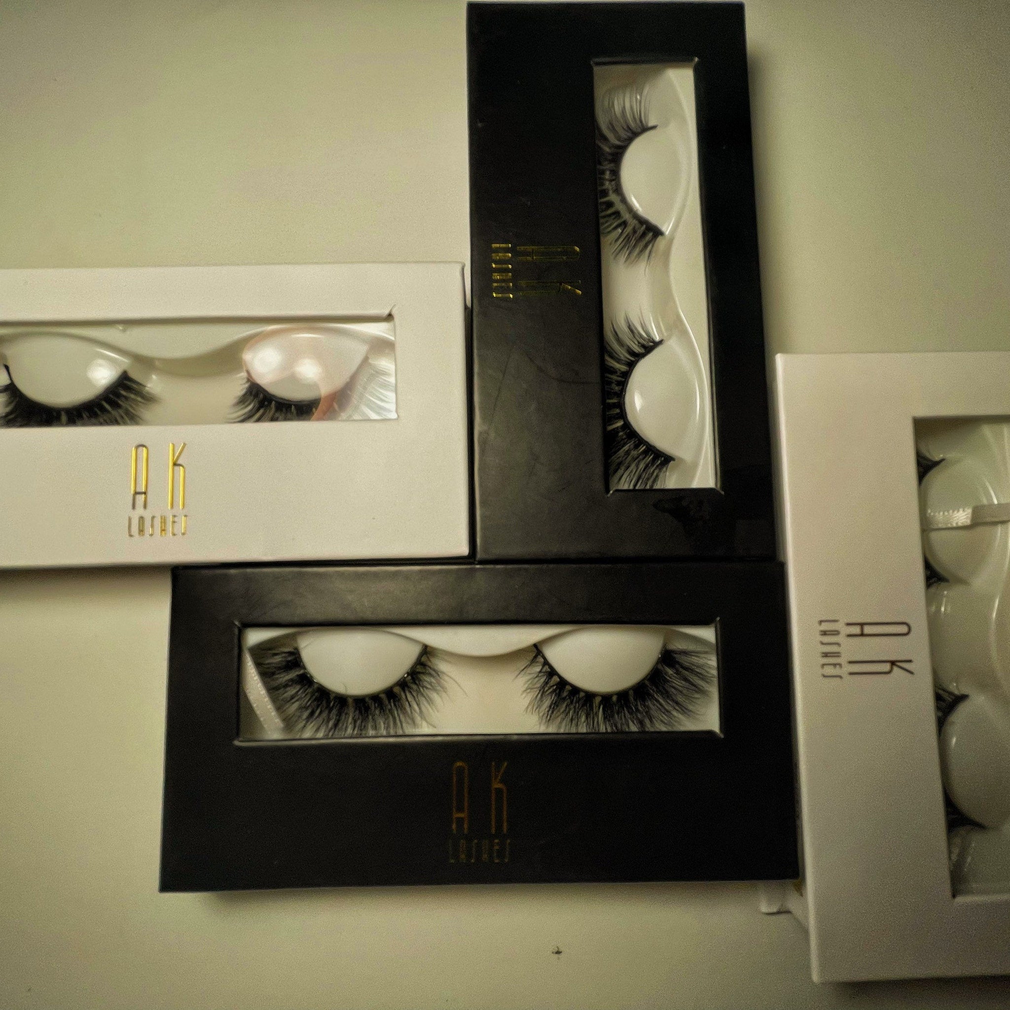 False eyelashes black mink style with AK Lashes branding in boxes