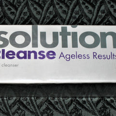 Solution cleanser box with white, purple, and gray text on patterned background