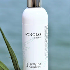 Purifying Cleanser bottle, white with silver cap, Synolo Skincare branding, botanical design