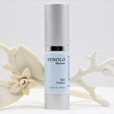 Eye cream bottle with silver cap and light blue label, Synolo Skincare brand