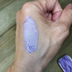 Close-up of unicorn-inspired eye shadow palette showing iridescent pastel shades in matte and shimmer finishes