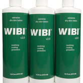 Three white plastic bottles of Wibi Extreme Dry Skin Lotion with blue caps and minimalist labeling, 16oz each