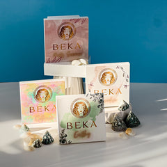 Four-pan eyeshadow palette with shimmering bronze, plum, taupe, and champagne shades in sleek black compact