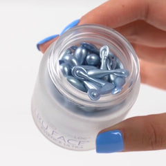 Face serum capsules, blue pearlescent, oval shape, in a clear glass jar, ageLOC brand visible