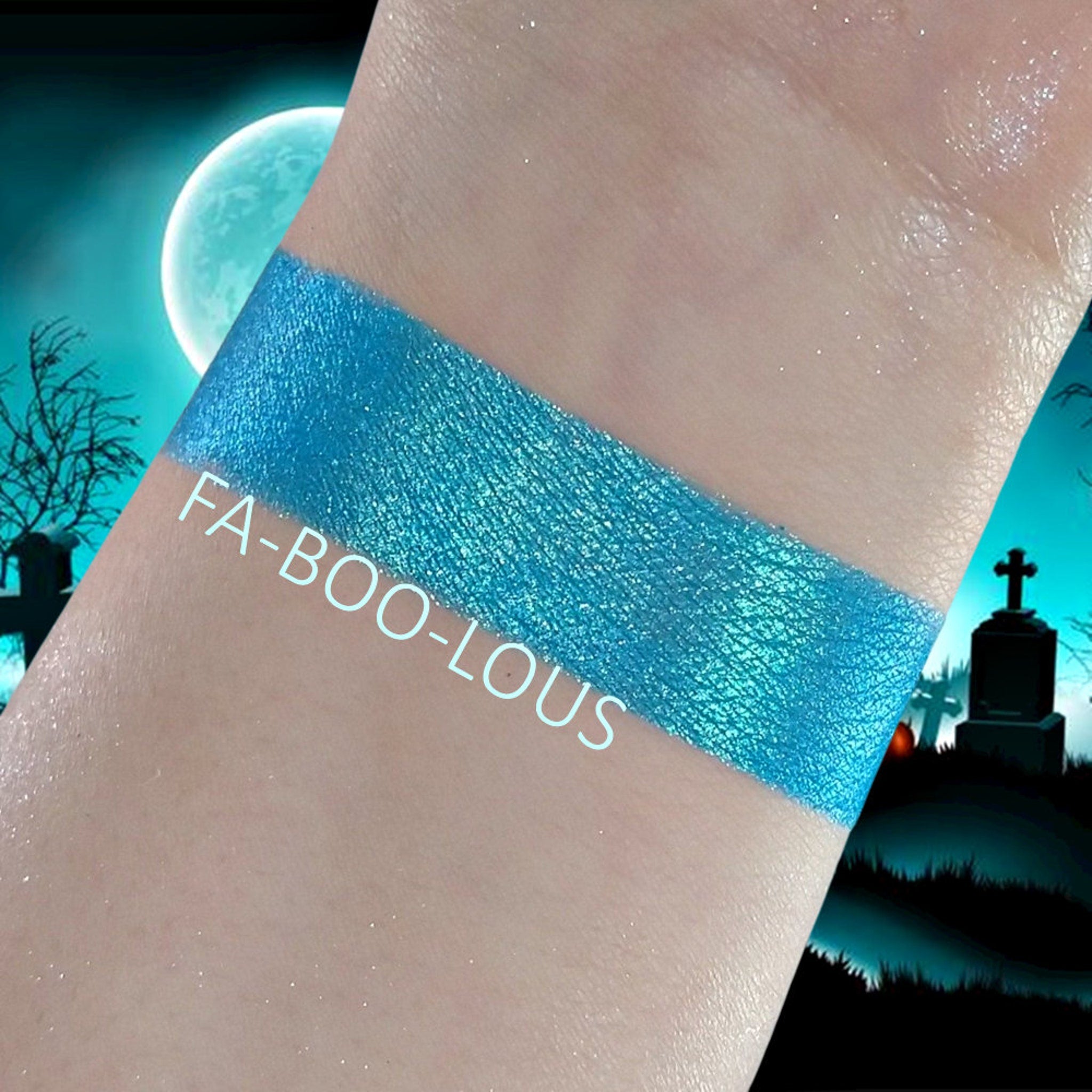 Close-up of Faboolous Duochrome Eyeshadow pot showing shifting iridescent purple and green hues