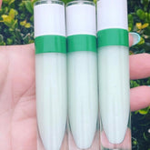 Lip gloss tubes with white and green accents, held in hand