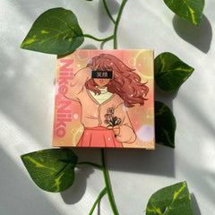 Niko Niko box with anime illustration, pink and orange colors, and floral details surrounded by green leaves