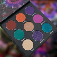 Eyeshadow palette with multiple colors including purple, orange, and green in a black compact case