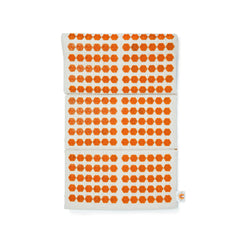 Acupressure mat with orange flower-shaped points on a light fabric, stacked style