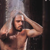 Sauna accessories: Man under water, wet skin, dark background, washing hair