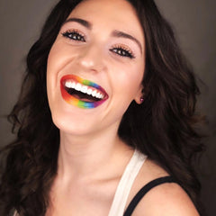 Hand applying vibrant yellow cream-to-powder eyeshadow with fingertip for smooth blendable coverage