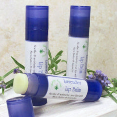 Lip balm tubes in blue and white, with lavender sprigs, Flaherty Naturals brand visible