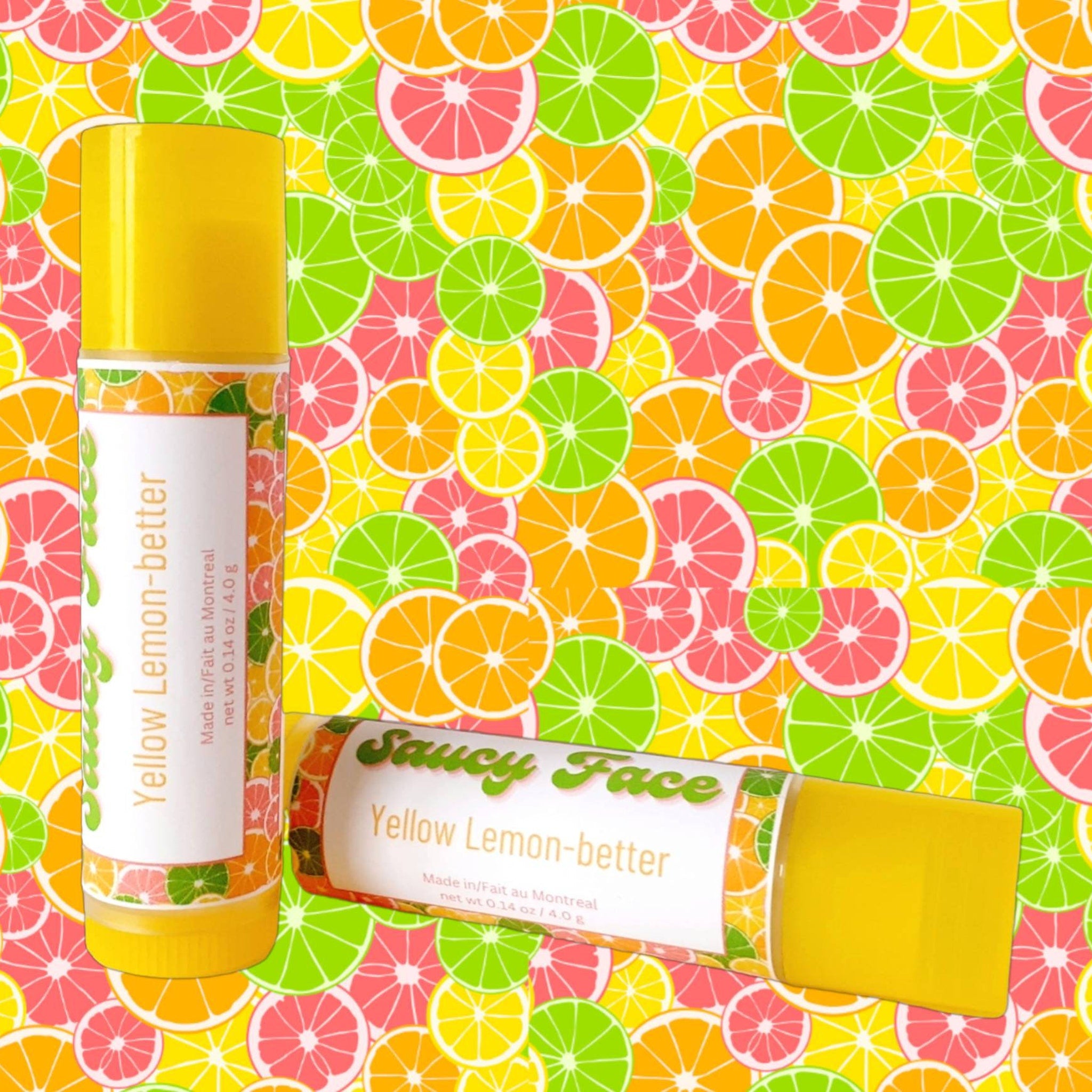 Lip balm tube with yellow and white label, "Saucy Face" text, citrus fruit background
