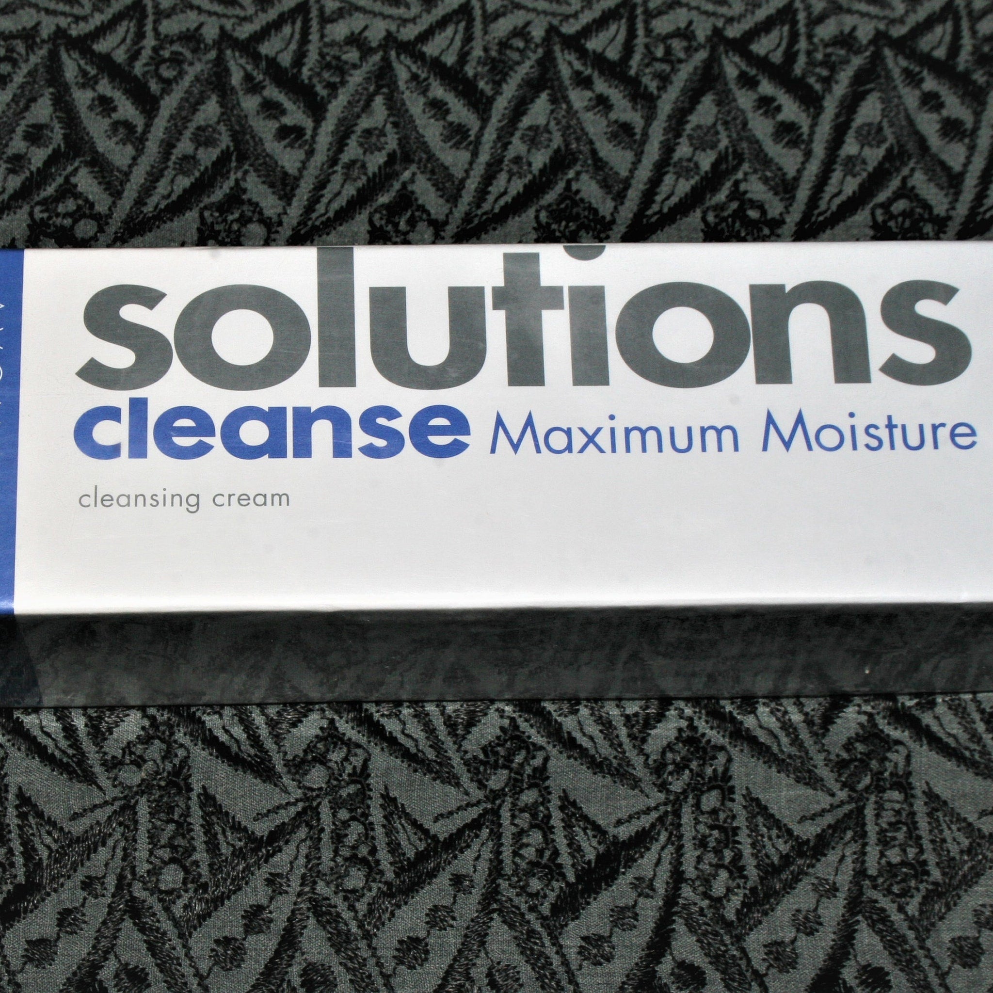 Facial Cleanser product, white box with blue text, "Avon Solutions" printed on it.