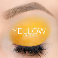 Close-up of vibrant yellow cream-to-powder eyeshadow with smooth, velvety texture in compact packaging