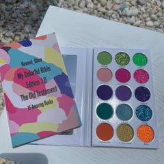 Eyeshadow palette with colorful eyeshadows, Revival Glam branding, and an open book with abstract design