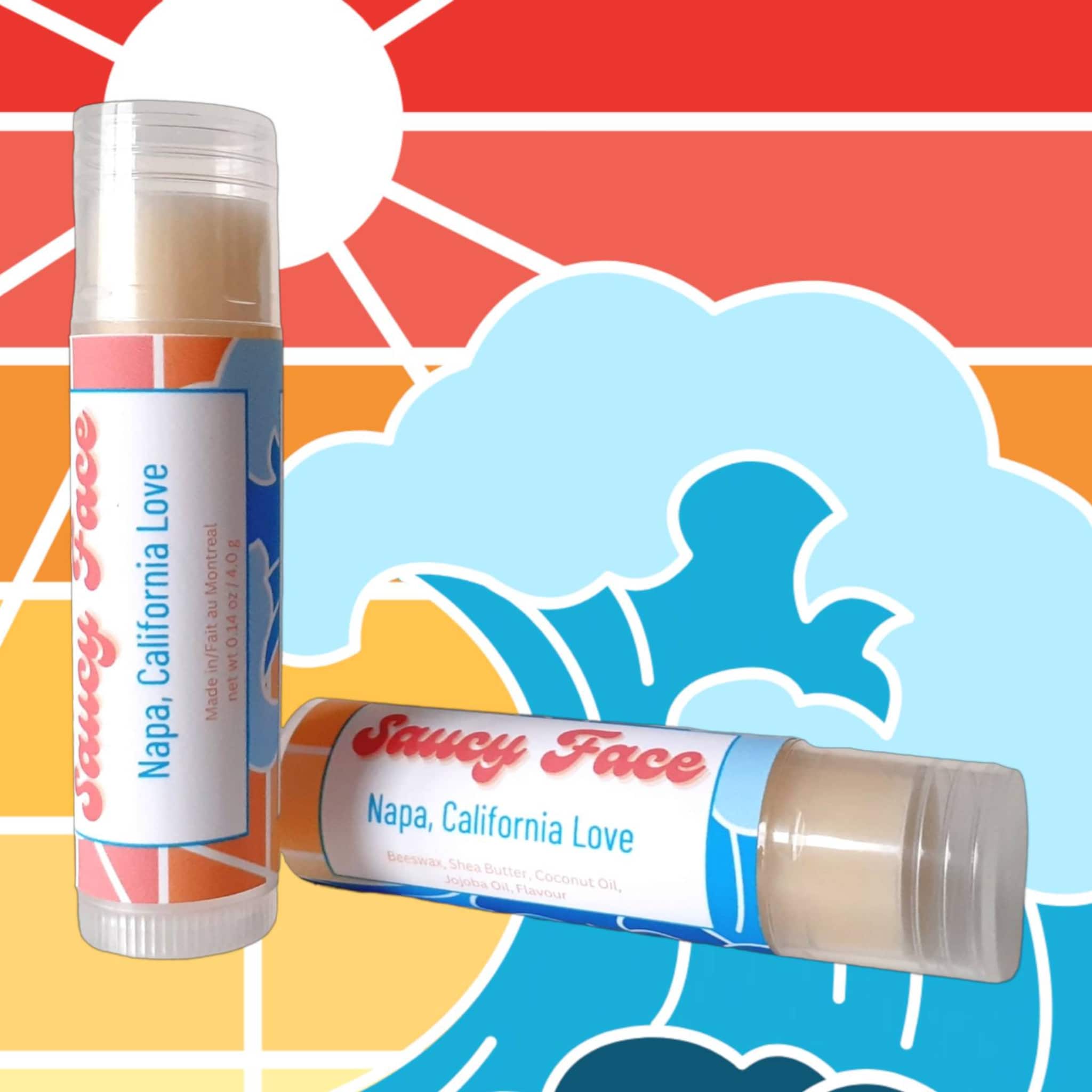 Lip balm tubes with clear plastic, white and blue labels, and Saucy Face text