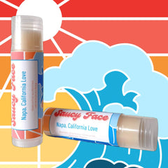 Lip balm tubes with clear plastic, white and blue labels, and Saucy Face text