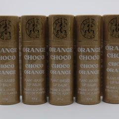 Lip balm tubes, brown paper material, white text, "GLEAM & GLOW" brand logo visible