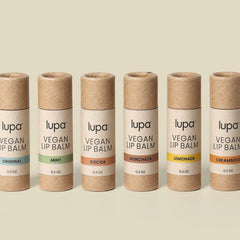 Vegan lip balm tubes in brown cardboard with colorful flavor labels, Lupa brand