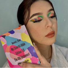 Bible book with colorful abstract pattern, held by person with makeup, Revival Glam branding visible