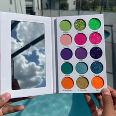 Eyeshadow palette with multiple colors, glitter, and mirror, held by hands, My Colorful Bible brand