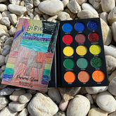 Eye makeup palette with colorful eyeshadows, black case, and Bible Palette cover art