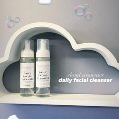 Daily facial cleanser bottles with white labels, clear liquid, and white pump tops displayed on a cloud shelf, Cloud Cosmetics