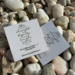 White square cards with black script text, Revival Glam by Mrs Piure books on rocks