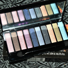 Close-up of vintage Avon eyeshadow compact showing shimmering bronze and taupe shades in rectangular pans