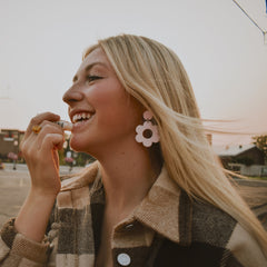 Lip balm tube being applied, white and clear tube, used on smiling woman's lips