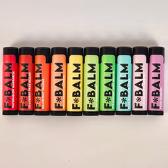 Lip balms in various colors with black caps and F*BALM brand text visible