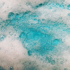 Bubbles with white and teal colors, close-up of foamy texture