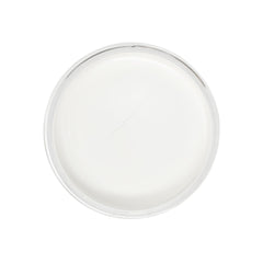 White cream in clear glass bowl with crack, top view