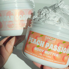 Body butter jars with white and peach labels, and whipped white cream, Soogs Body Care