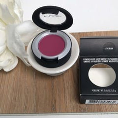 Eye shadow compact with magenta color, black and silver case, MAC brand visible