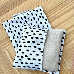 White and black patterned fabric with a natural linen insert, Designed by Claire label visible