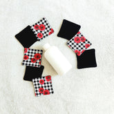 Makeup remover pads with black and floral plaid fabric, with a white bottle on white towel