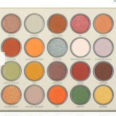 Eyeshadow palette with various fall colors, including orange, brown, and green eyeshadows in round pans