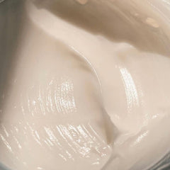 Creamy white cream with glossy texture and smooth surface, close-up view