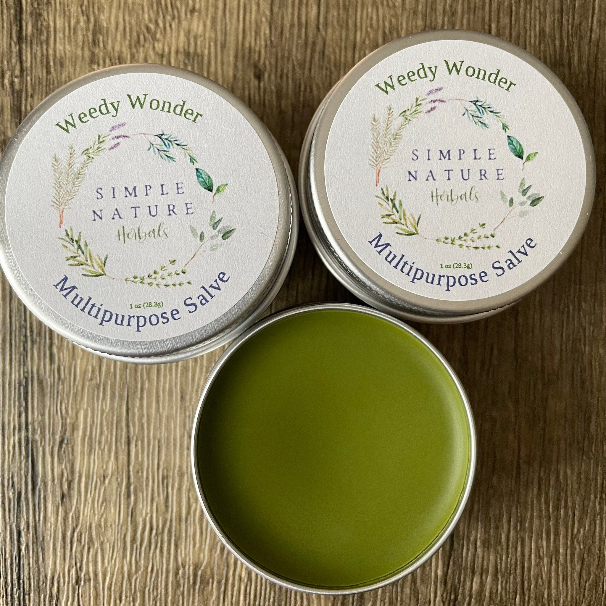 Multipurpose salve in metal tins, green salve visible, "Weedy Wonder" brand