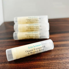 Lip balm tubes with white and yellow colors, clear cap, and "från krämer" text on wooden surface