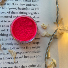 Woman applying emerald green shimmer eyeshadow with a blending brush to her eyelid