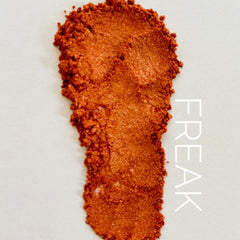 Orange metallic powder swatch with "FREAK" text on white background