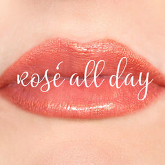 Lipstick with coral color and glossy finish, "Rose All Day" text on lips