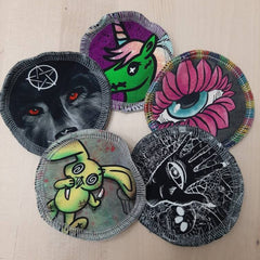 Patches with wolf, unicorn, eye, hand, and bunny designs, various colors, stitched edges