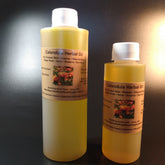 Calendula oil bottles, yellow liquid, white cap, Bumbling Acres Farm label on bottles