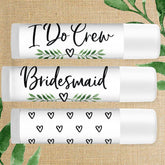 Bridesmaid lip balm with white tube, black text, and green leaf design for wedding favors